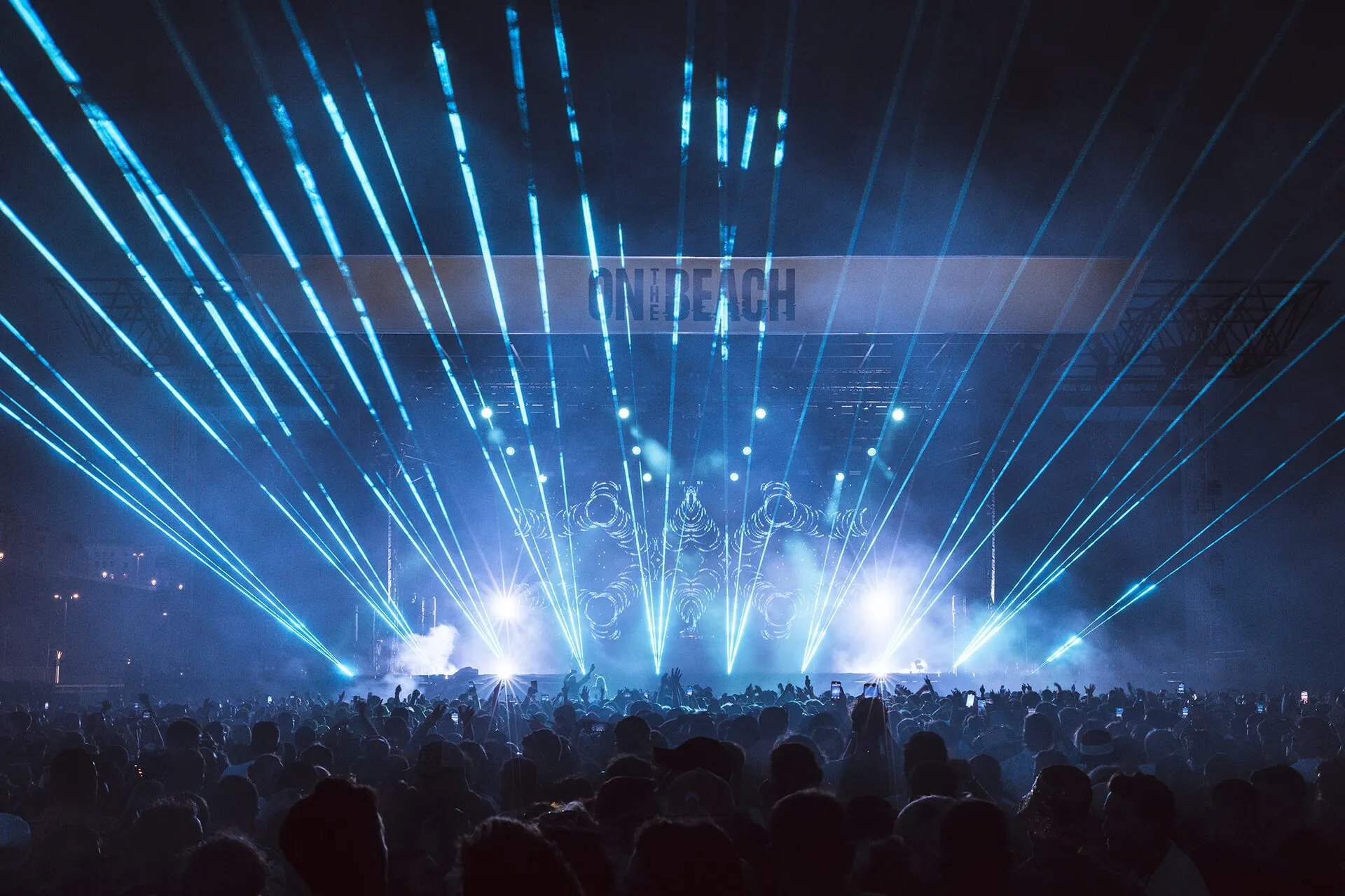 Festival-goers dancing on the pebbles